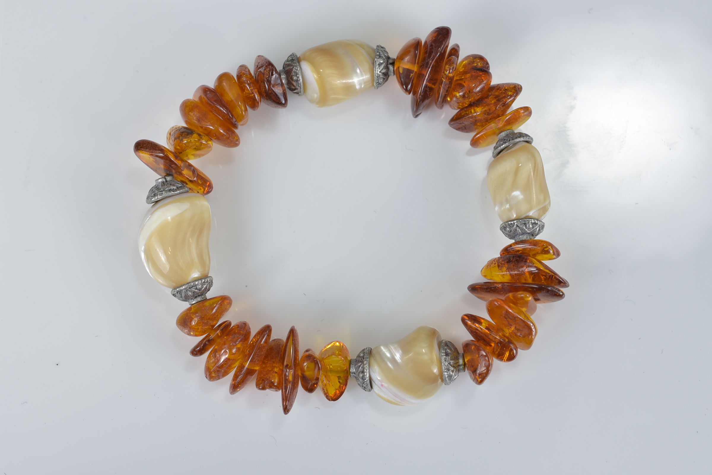 A Baltic amber and mother of pearl bracelet together with a silver charm bracelet with eight charms, - Image 3 of 4