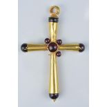 A gold cross pendant with garnet stone (one stone missing). 6cm height