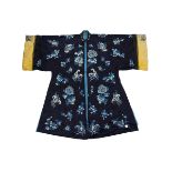 A Chinese 19/20th century blue ground embroidered jacket with flowers and butterflies, rolled yellow