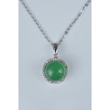 A Jadeite stone pendant set in silver chain and setting with box. Purchased in Shanghai. Stamped 'It