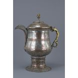 A large white metal ewer with cover and handle