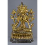 A large Tibetan gilt bronze figure of Buddha with character marks. 70cm tall