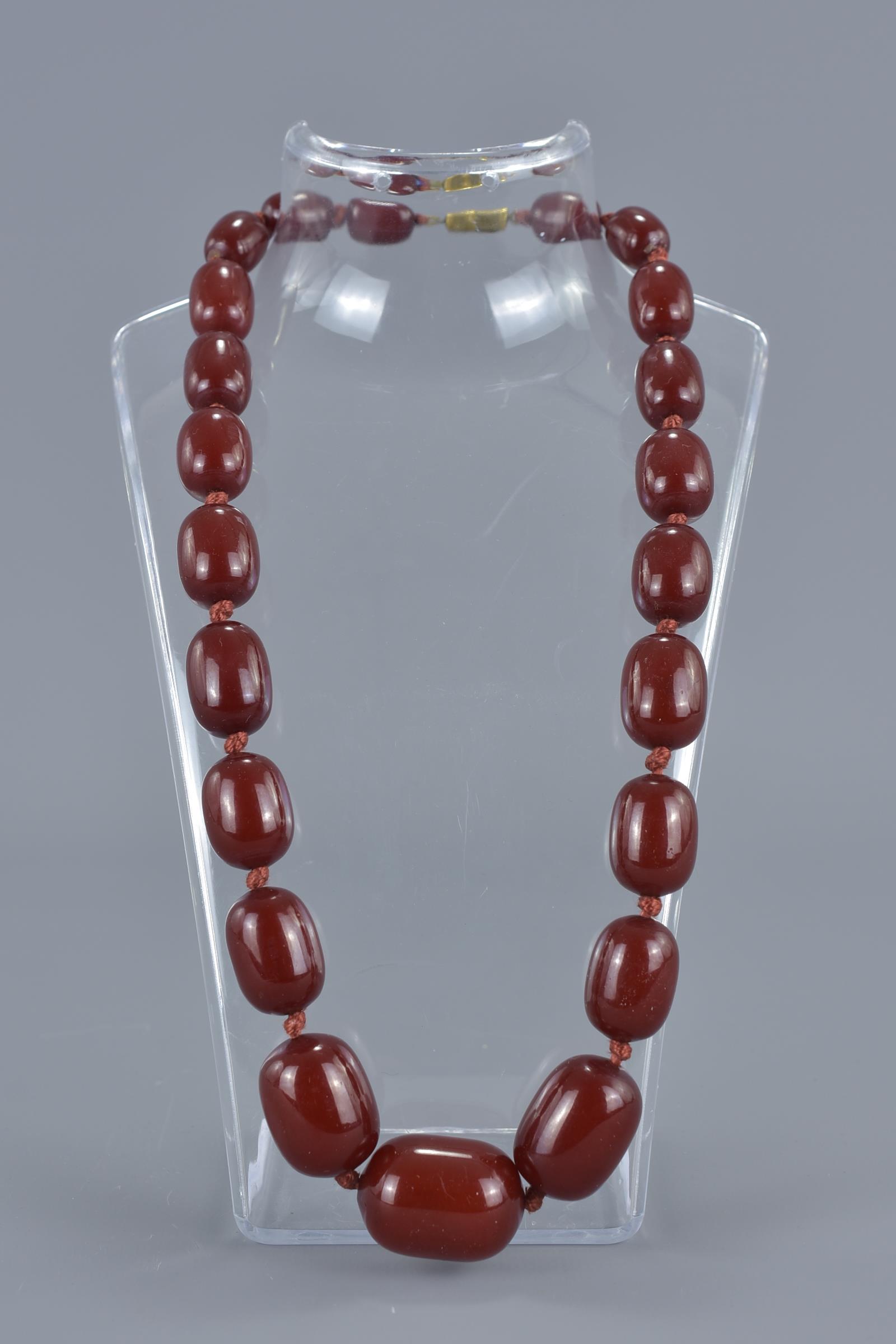 An antique cherry amber Bakelite beaded necklace.