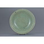 A Chinese Ming dynasty celadon porcelain dish with crackle glaze. 37.5cm diameter