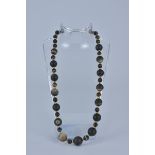 A banded Agate necklace with Gold Metal Spacers.