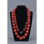 A graduated coral bead necklace.