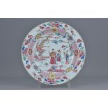 A Chinese 18th Century famille rose porcelain dish decorated with figures and Phoenix. 22cm diameter