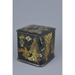 A Japanese lacquer Tea Caddy with Gold Gilding decorated with figures in garden. 11cm x 11cm