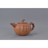 A 20th Century Chinese Yixing Teapot in the form of a pumpkin.  Inscription and makers mark to base.