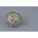 A Tibetan silver-plated incense prayer ball.  6cm diameter