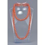 A long string of 108 coral beads.