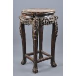 A Chinese 19th century hardwood plant stand. 60cm tall