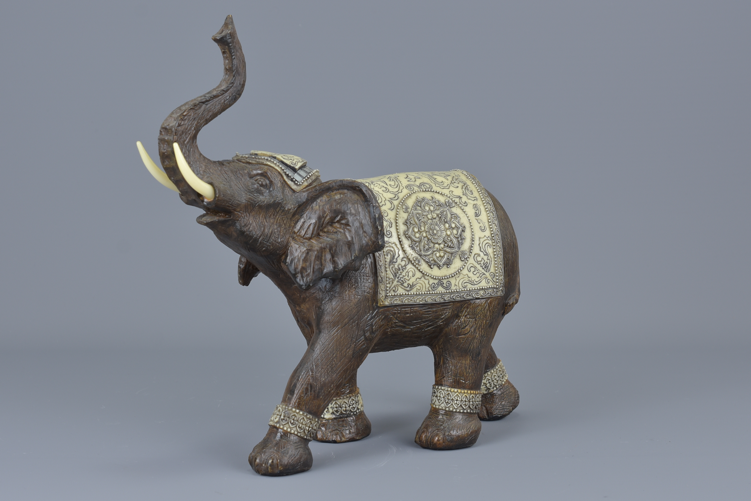 An Indian carved wooden elephant. 25cm x 24cm