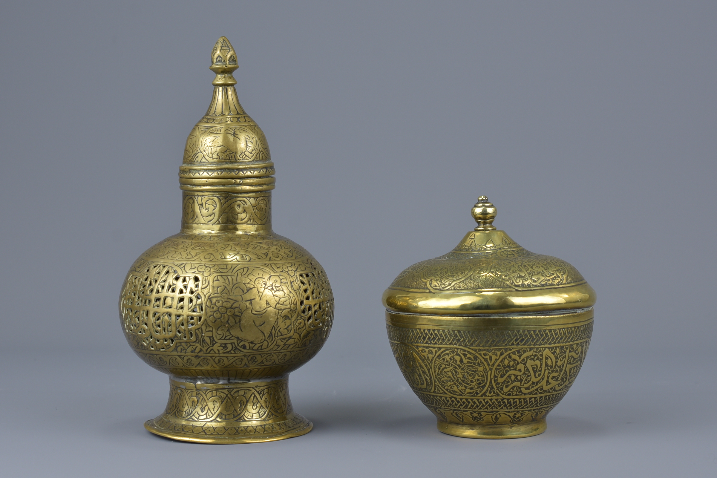 Two  Islamic brass items with covers with pierced decoration and bowl with inscription. 18cm height
