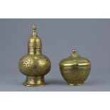 Two  Islamic brass items with covers with pierced decoration and bowl with inscription. 18cm height