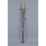 A Chinese decorative sword with carved celadon jade handle. Decorated with stone beads. Purchased in