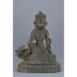 An 18/19th century Chinese bronze Guanyin seated on a mythical beast with traces of gilding. 55cm ta