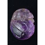 A Chinese amethyst pendant with lizard on top of a peach. Small hole for string on top. Size 3.5cm x