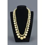 A long vintage graduated ivory beaded necklace. Total 145 beads. Largest bead approx. 2.3 cm diamete