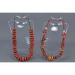 Coral, White Metal and Amber Coloured Bead Necklace together with a Red Stone Bead Necklace