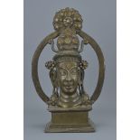 An Eastern bronze figure on stand. 37Cm tall