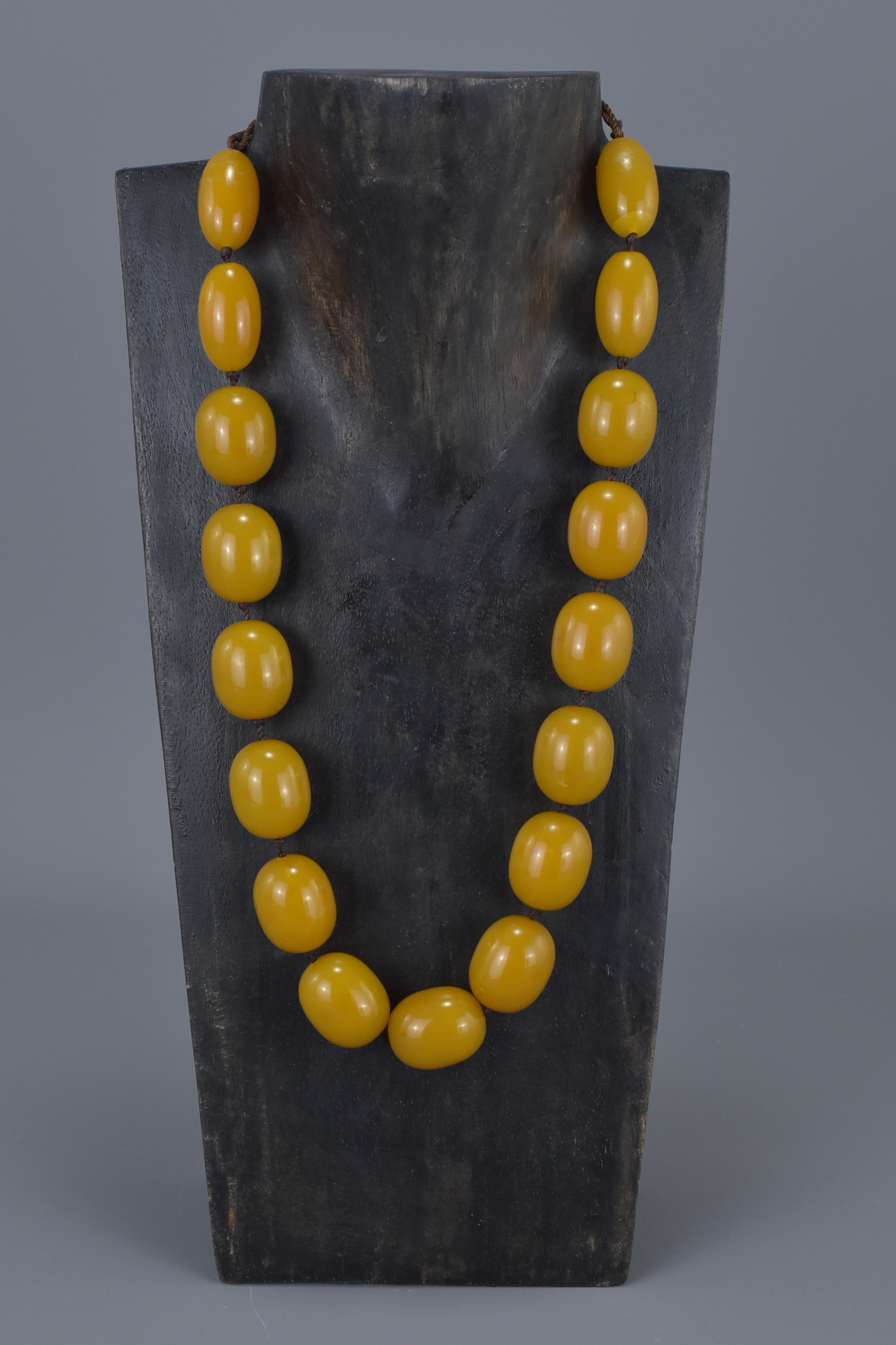 Amber Coloured Necklace containing 17 String Strung Beads, approx. 90 grams