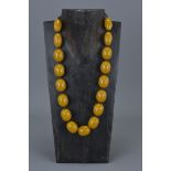 Amber Coloured Necklace containing 17 String Strung Beads, approx. 90 grams
