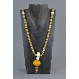 Ethnic Stone Bead Necklace with Pendant formed from Bone & Three Amber Style Beads, approximately 78