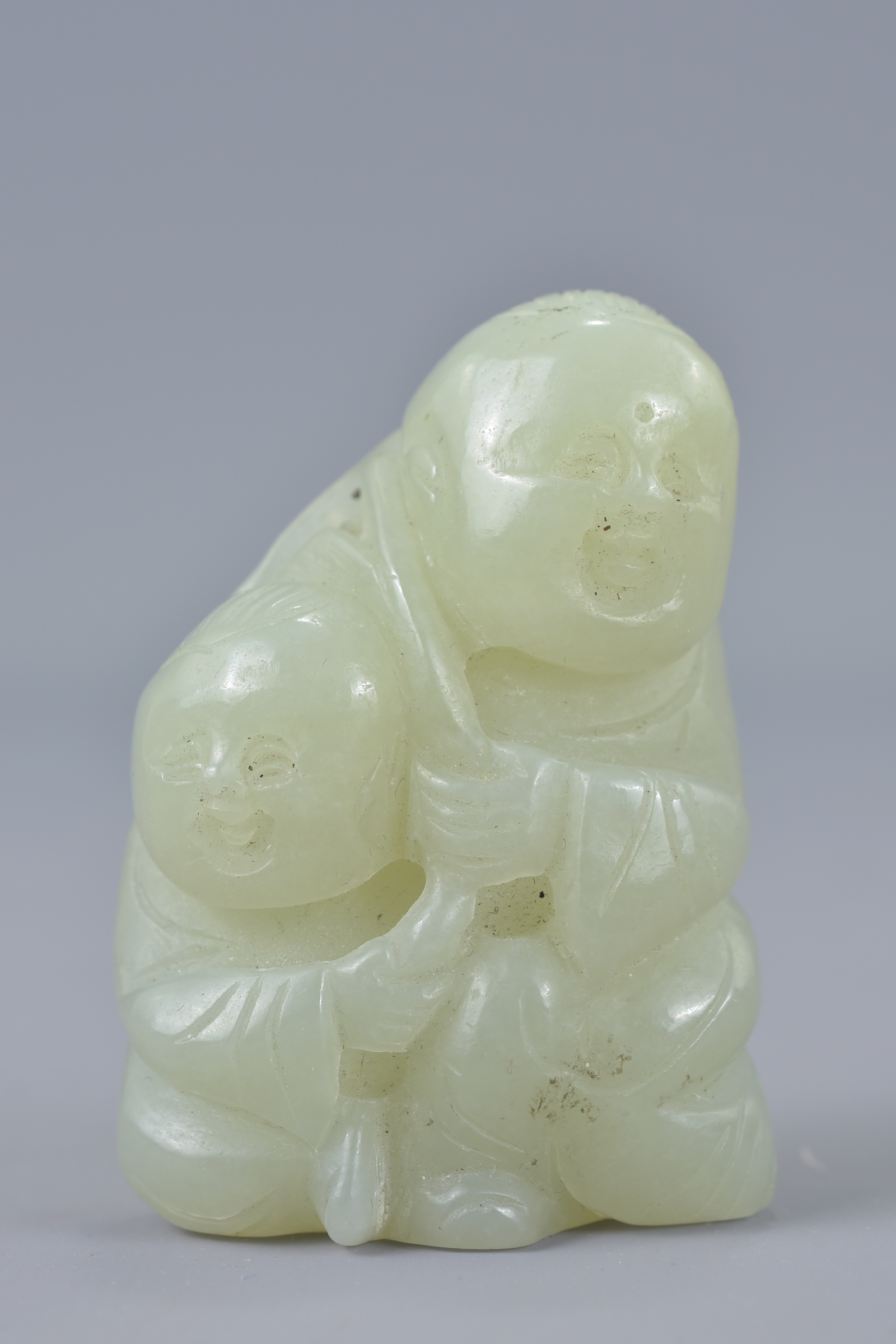 A Chinese 19/20th century pale celadon jade carving of two boys. Size 5.7cm tall x 3.8cm wide