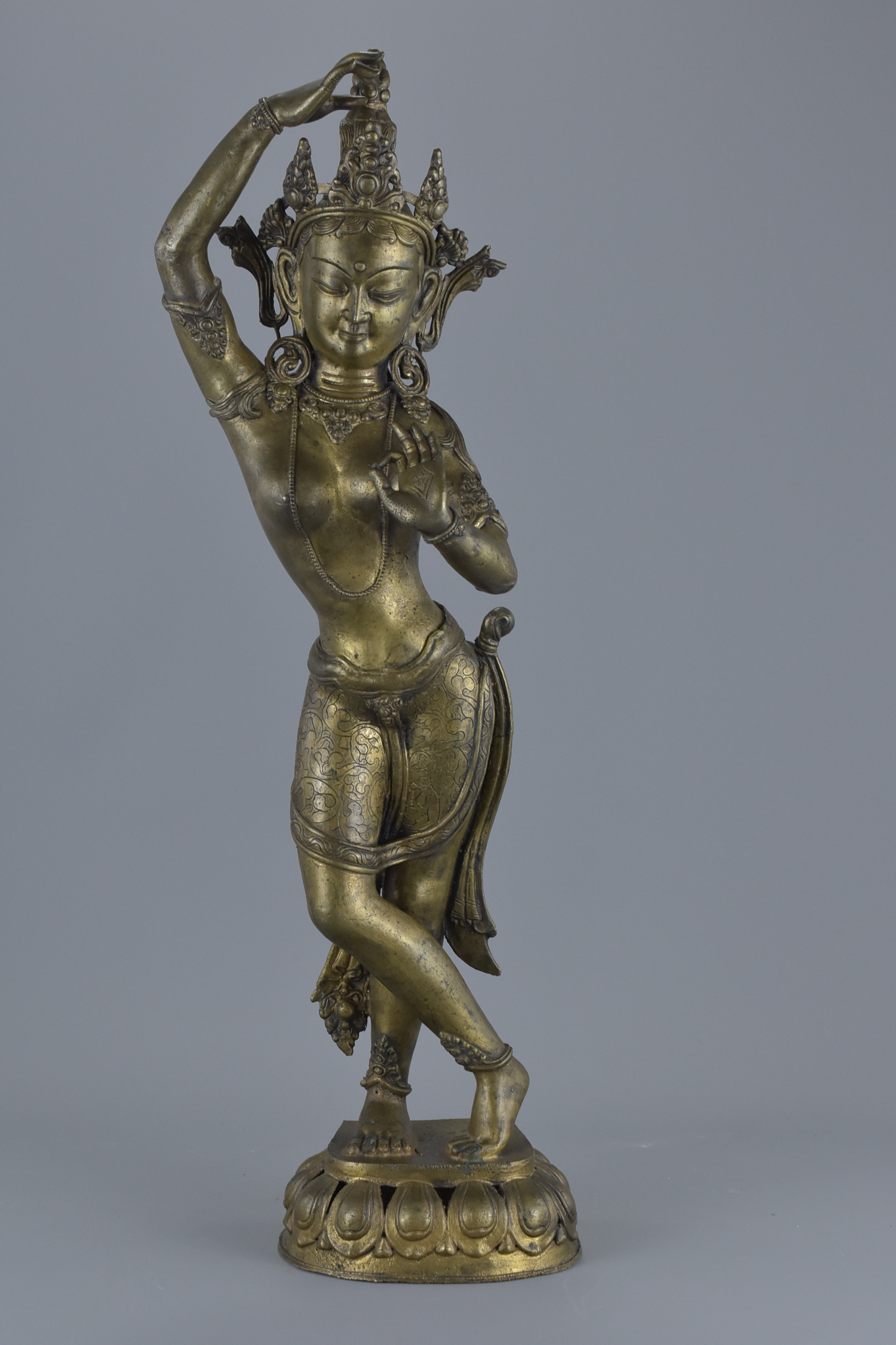 A tall Tibetan bronze standing dancing Tara figure on stand. 57Cm tall