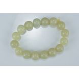 A Chinese pale green jade beaded bracelet. Total 16 beads. Beads approx. 2.3cm diameter