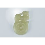 A Chinese pale celadon jade pendant carved with lion on disc. 6Cm tall x 3.5cm wide.