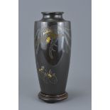 Japanese Bronze Vase with Inlaid Silver and Yellow Metal Decoration depicting a Phoenix on a Hardwoo