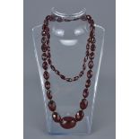 Cherry Amber Coloured Necklace containing 58 Faceted Graduating Beads