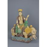 A Chinese sancai glazed pottery figure of Guanyin seated on an elephant. 48cm tall x 40cm width