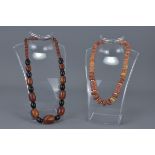 Amber Coloured and Black Bead Necklace comprising approx. 39 different size beads together with Ston