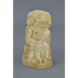 An African bone carving depicting lions chasing an elephant. 9.5cm tall