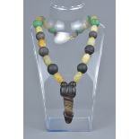 An agate phallic pendant on beaded necklace.