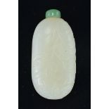 A Chinese 18/19th century white jade snuff bottle of long ovular form with incised decoration of but