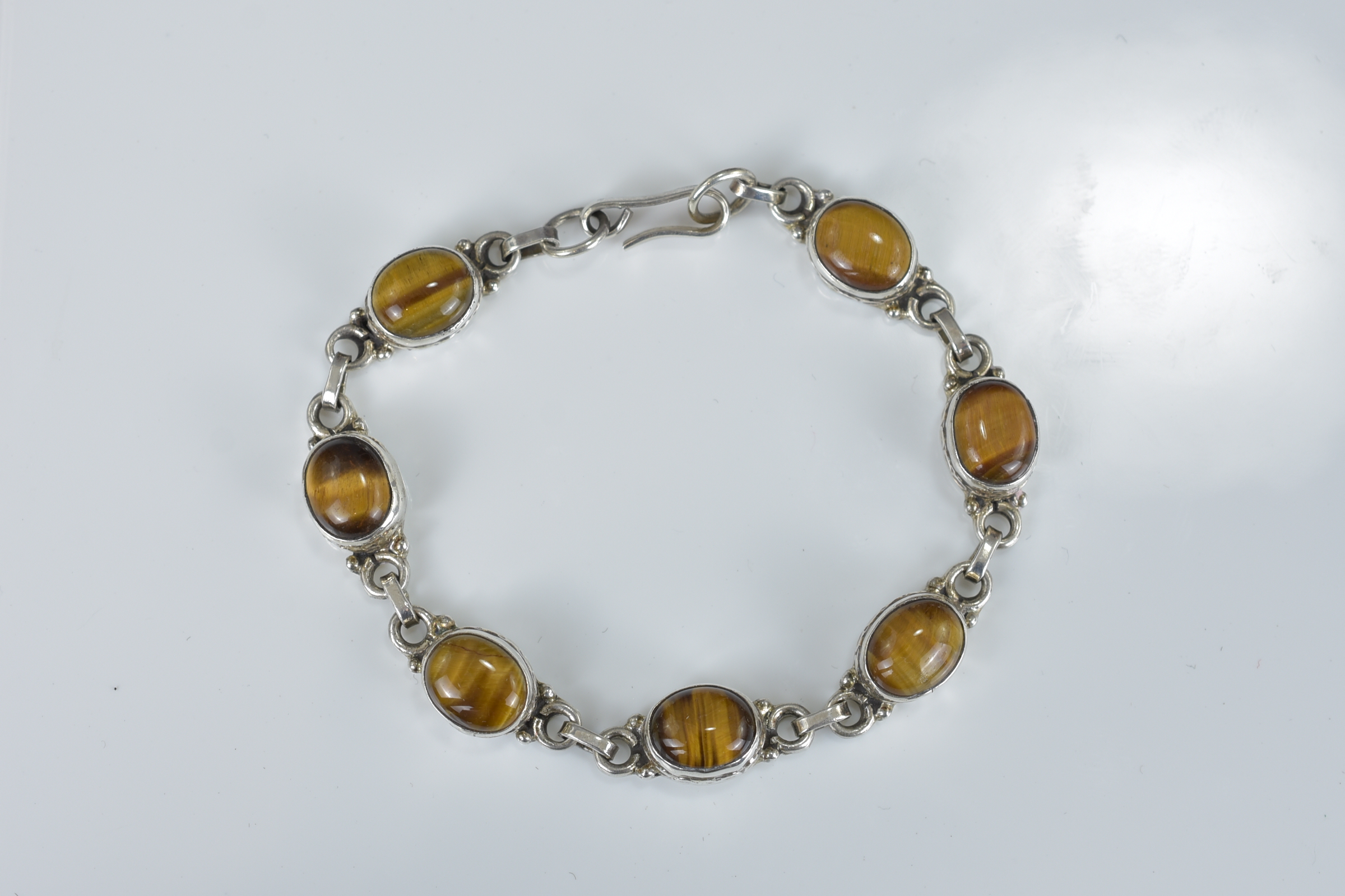 A Baltic amber and mother of pearl bracelet together with a silver charm bracelet with eight charms, - Image 4 of 4