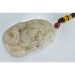 A large Chinese pale jadeite pendant carved as phoenix on mountain. 9Cm x 5cm