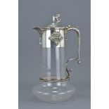 Late 19th / Early 20th century Glass Claret Jug with Silver Plated Mounts, the hinged lid with Lion