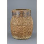 A large Chinese vintage wicker woven basket with five character Chinese shop mark to wooden frame wi