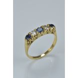 An 18ct gold ring with sapphire and diamonds. Size N