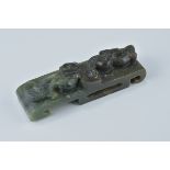 A Chinese dark green jade sword slider carved with dragon. 9cm length