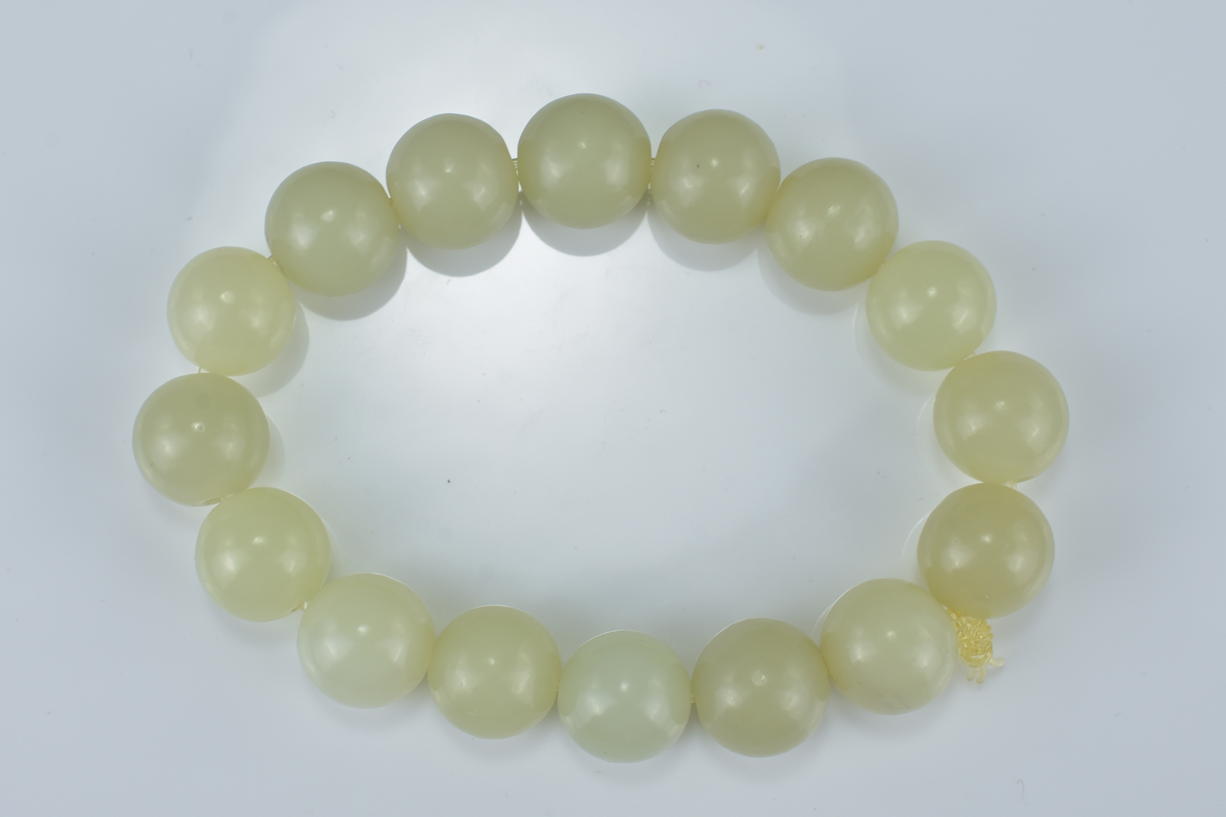 A Chinese pale green jade beaded bracelet. Total 16 beads. Beads approx. 2.3cm diameter - Image 2 of 2
