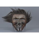 A large Japanese carved wooden ceremonial mask. 29cm x 25cm