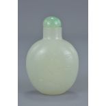 A Chinese 18/19th century mutton fat jade snuff bottle with inscided decoration of bat, cloud and fl