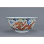 A Chinese 19th century famille rose dragon and phoenix porcelain bowl with a single iron-red dragon