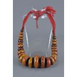 Large Moroccan Amber resin bead Necklace with silver inserts. 5cm largest bead